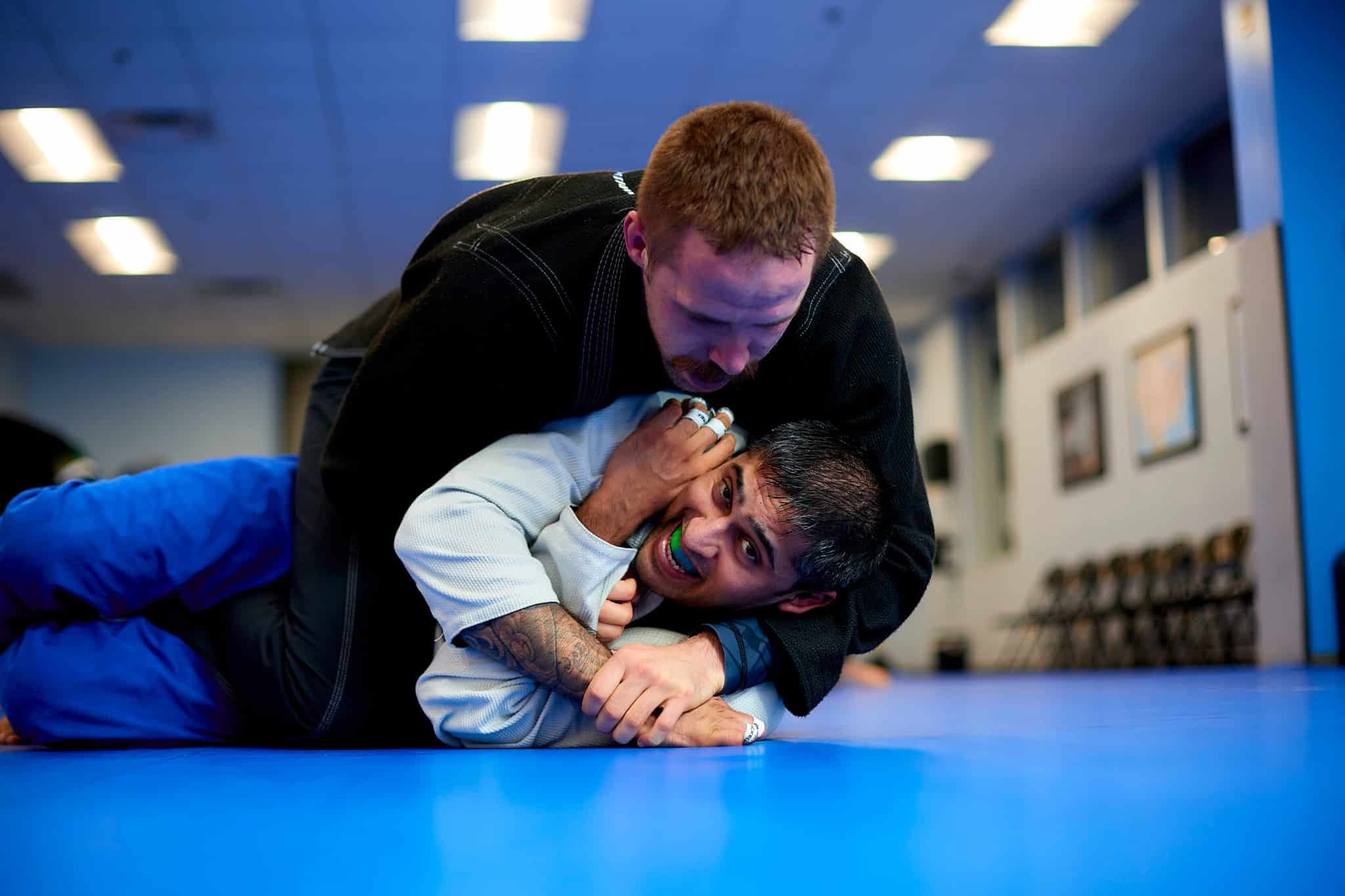 Two members locked in a hold on the mat