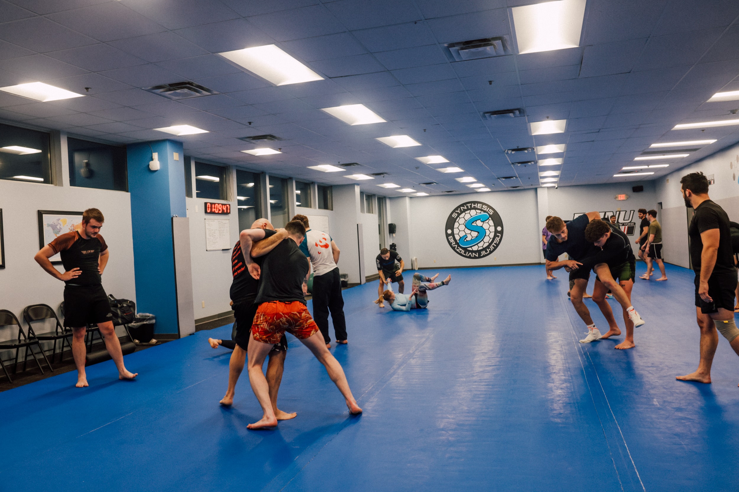 a class of members practicing their maneuvers on the mat