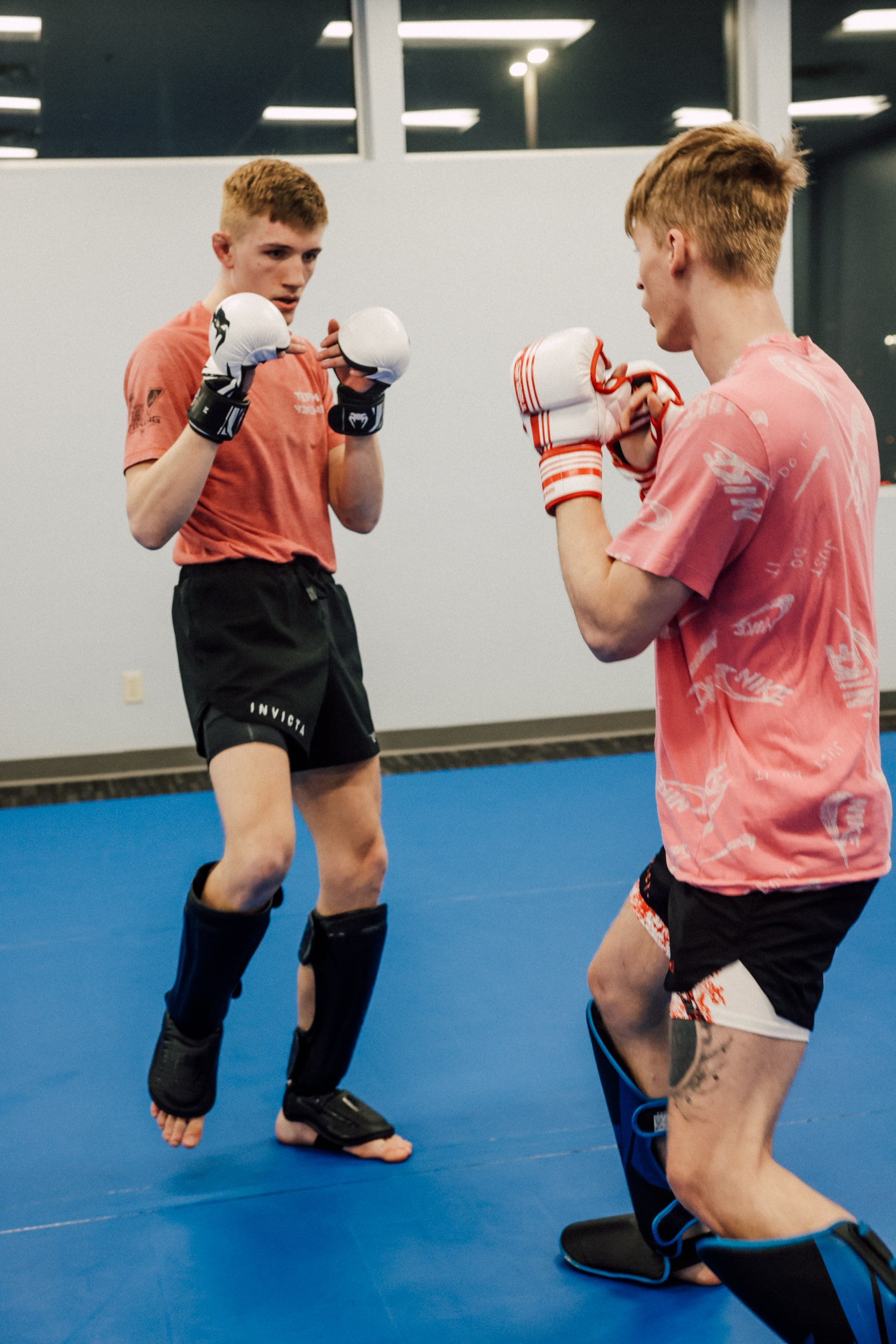 two members face each other ready to box on the mat