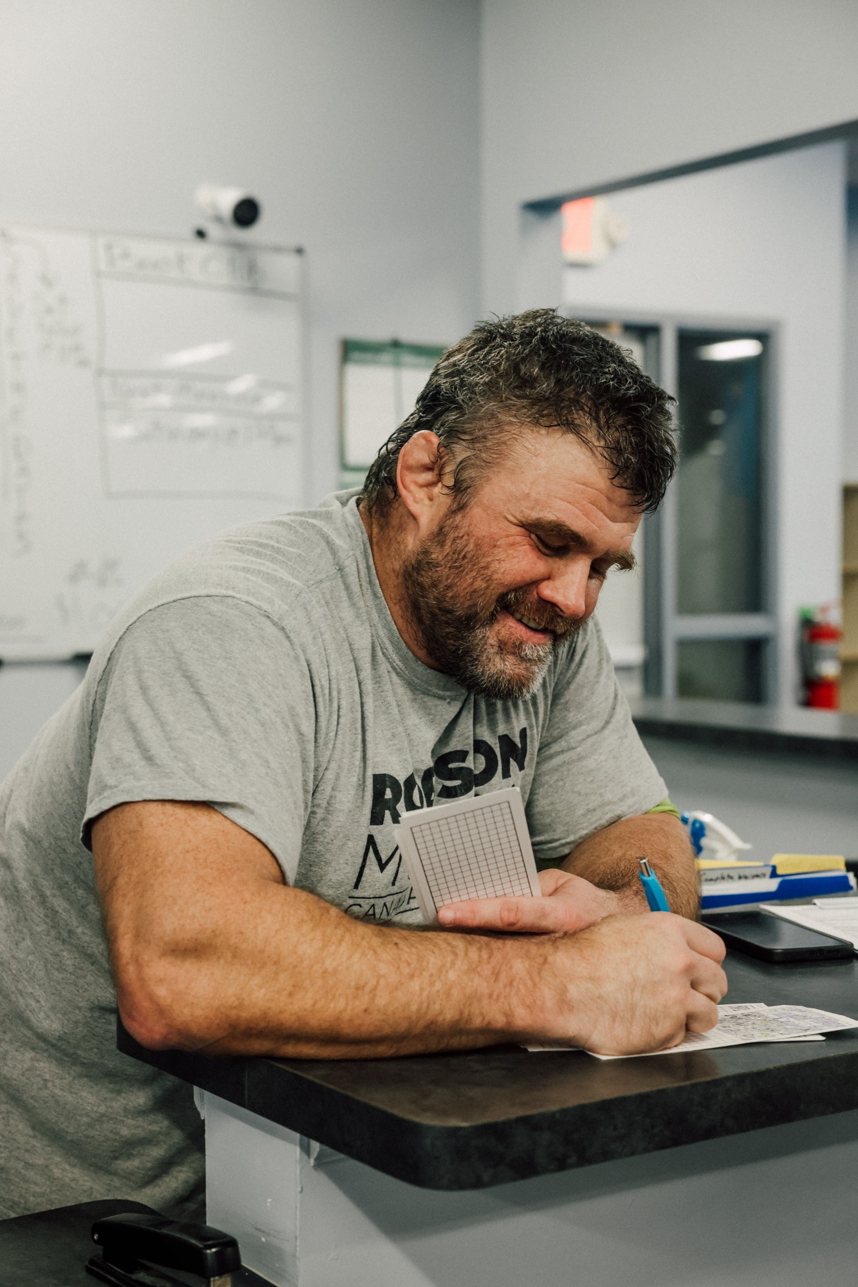 an instructor fills out papers in a back office