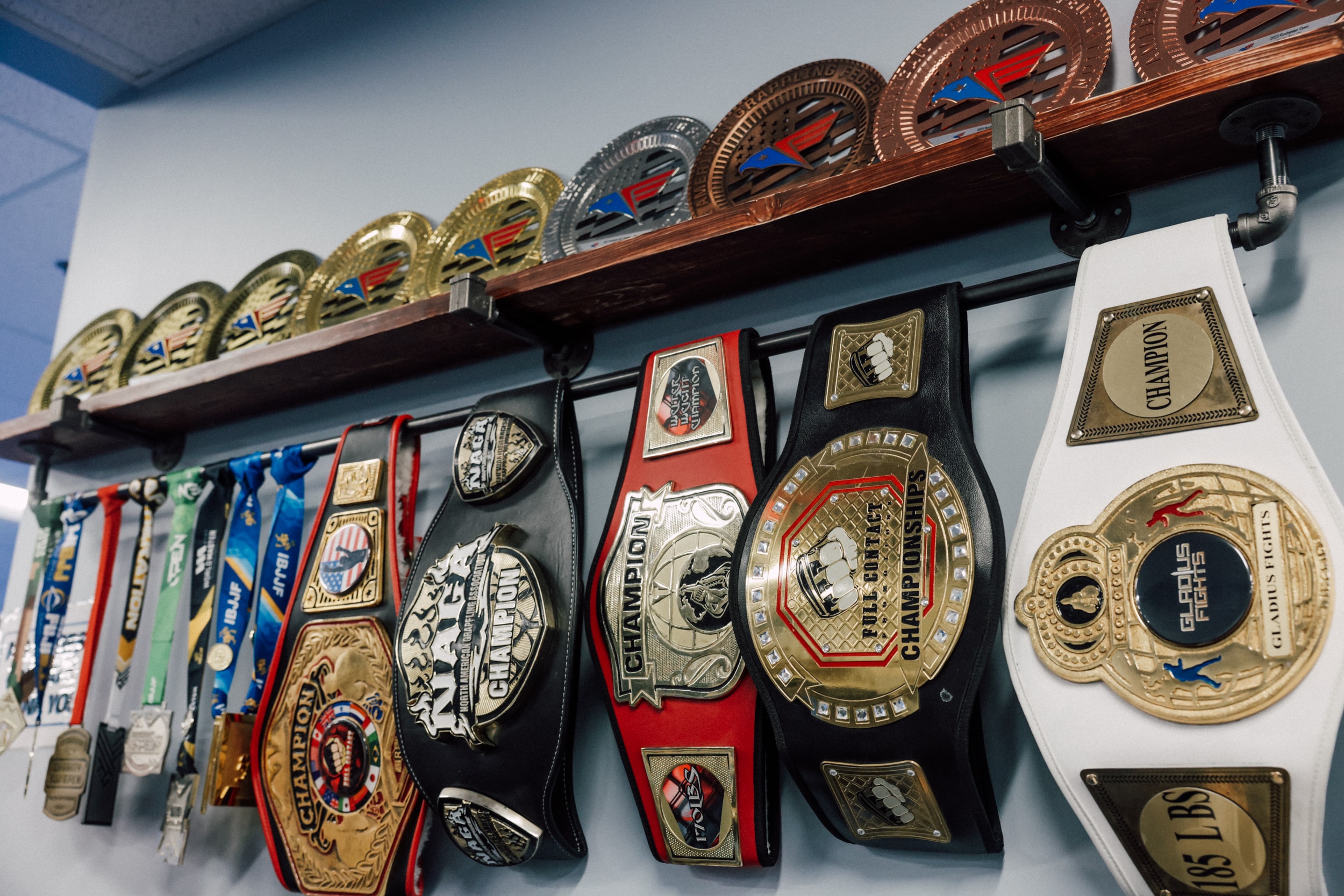 wall of champion belts and awards